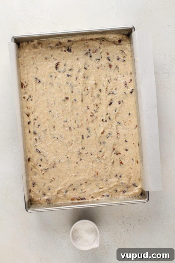 Decadent Date Cake Recipe with Warm Spices 7 Date cake batter spread into a cake pan, ready to go in the oven.