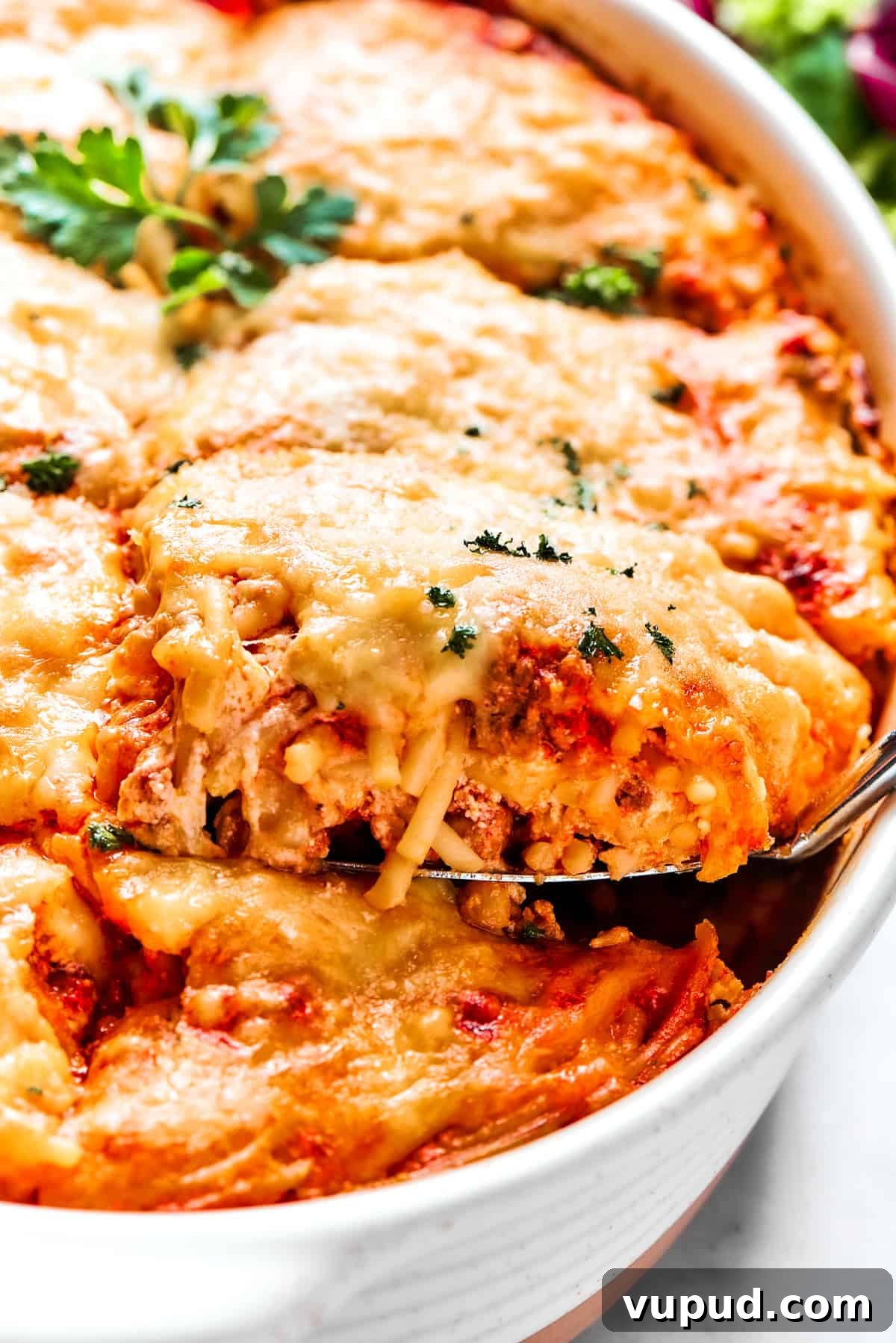 Million dollar spaghetti is an easy spaghetti casserole made from pasta tossed in homemade meat sauce and baked with layers of melty cheese. Spooning out baked spaghetti from a casserole dish.