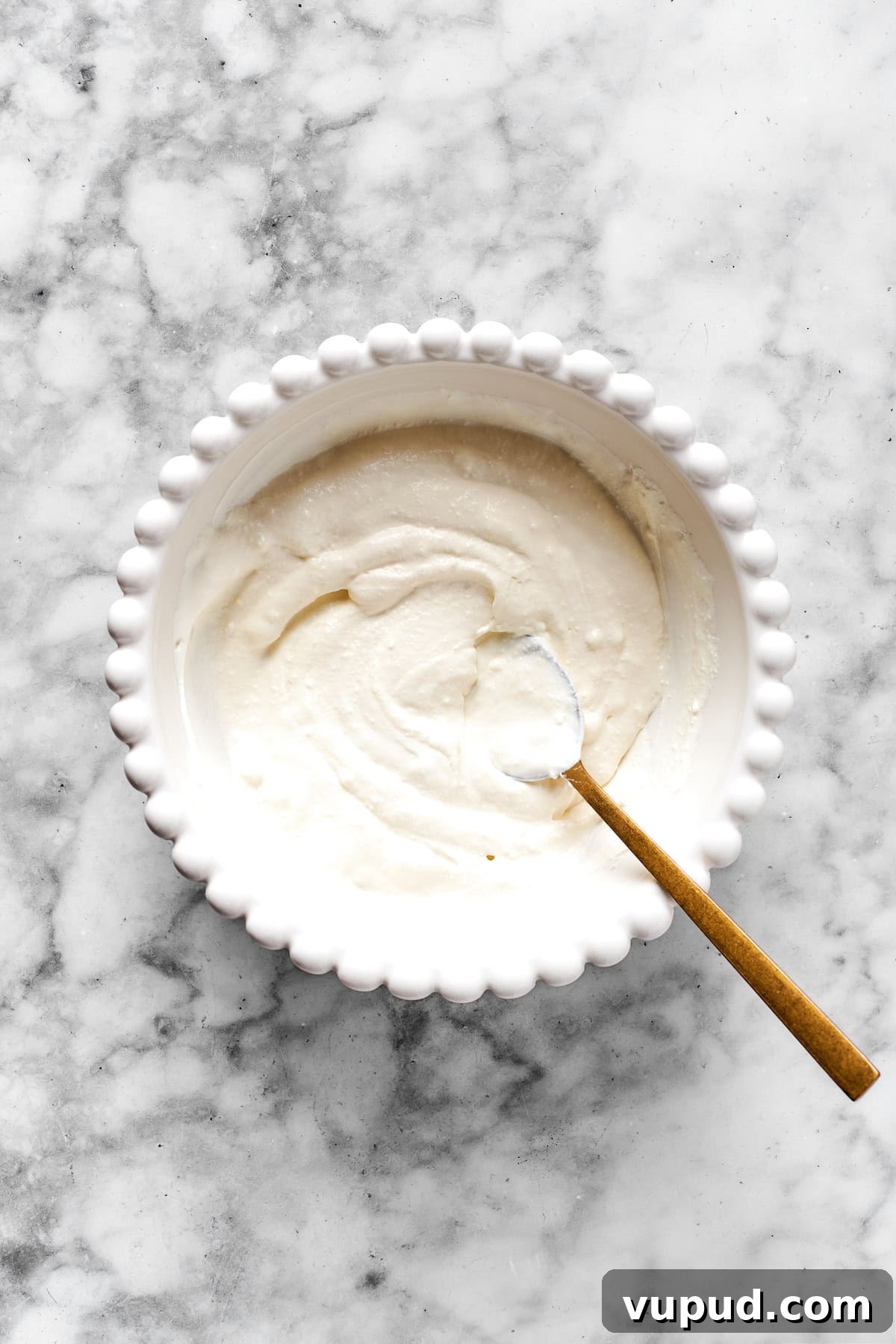 This is the texture you want. Finished cheese mixture in a white bowl.