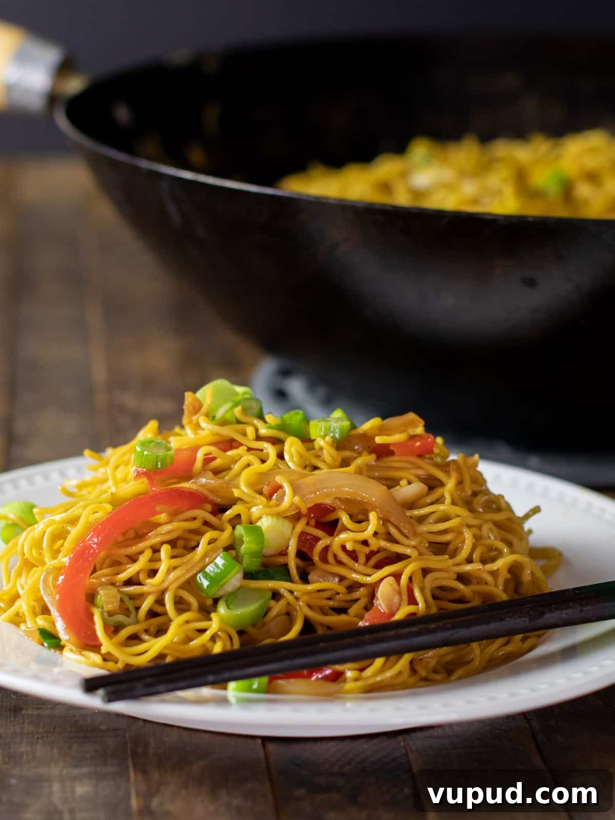 Vegetable Chow Mein Recipe: Flavorful Stir-Fry with Crunchy Veggies 2 Chow mein noodles on a plate with chop sticks.