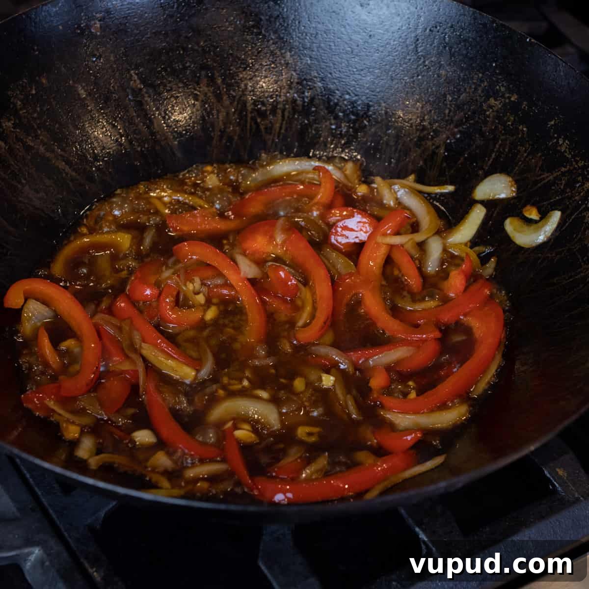 Vegetable Chow Mein Recipe: Flavorful Stir-Fry with Crunchy Veggies 5 Vegetables and sauce simmering in a wok.