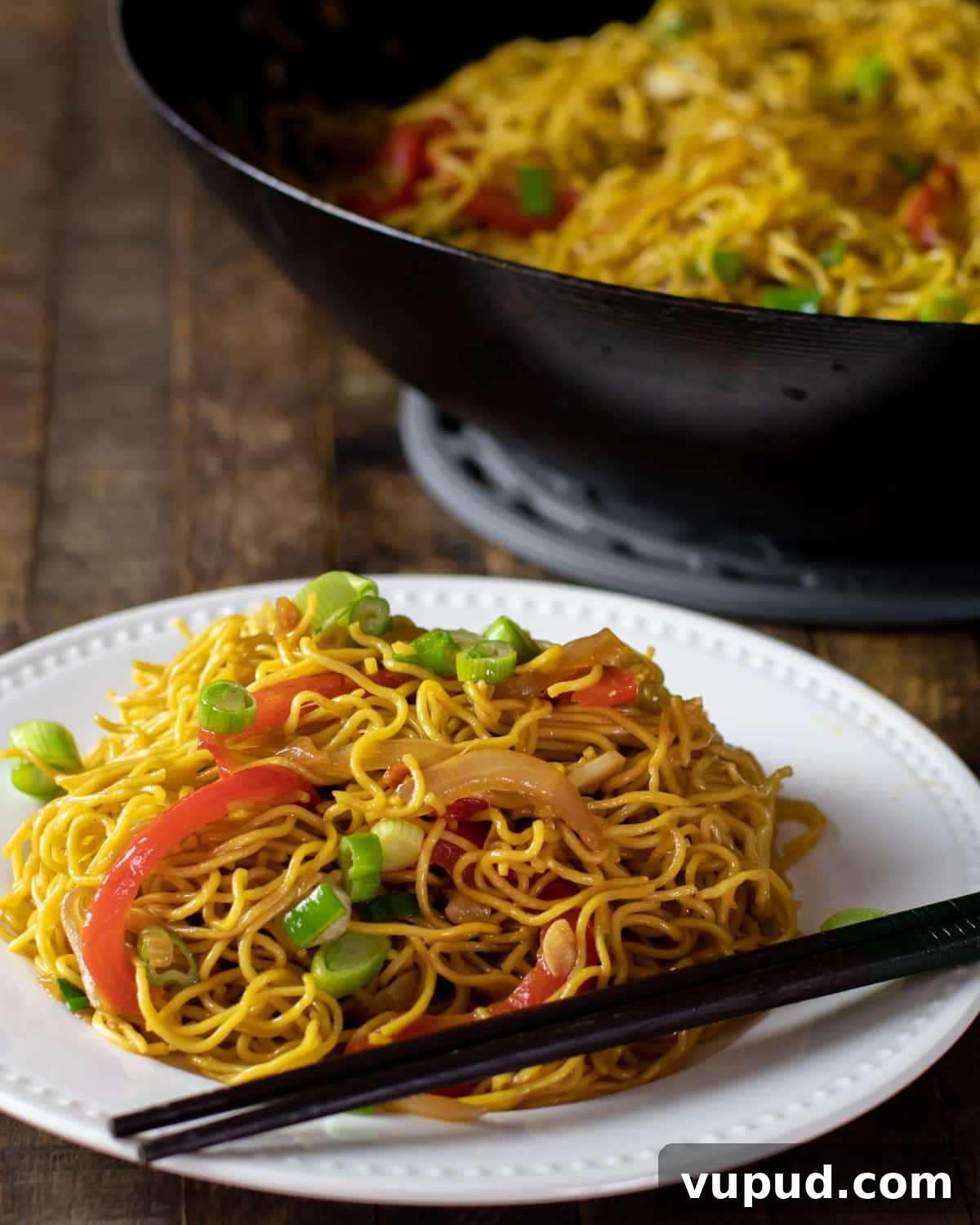 Vegetable Chow Mein Recipe: Flavorful Stir-Fry with Crunchy Veggies 8 Chinese noodles on a plate with chopsticks.
