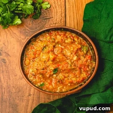 Smoky Roasted Tomato and Habanero Salsa Recipe 14 A bunch of cilantro next to a bowl filled with salsa.