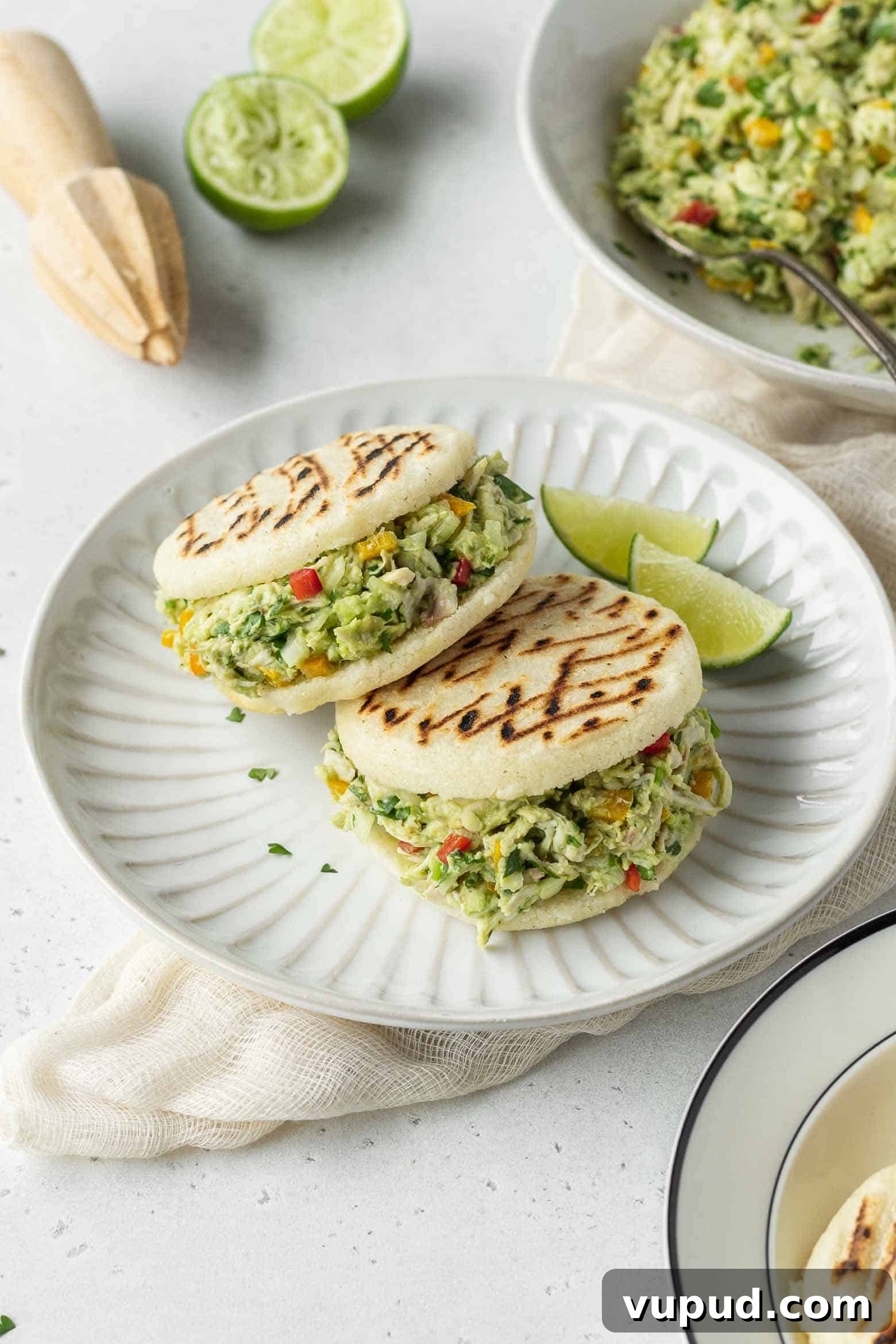 Reina Pepiada Arepa: Venezuelan Chicken & Avocado Recipe 11 Two reina pepiada arepas on a plate