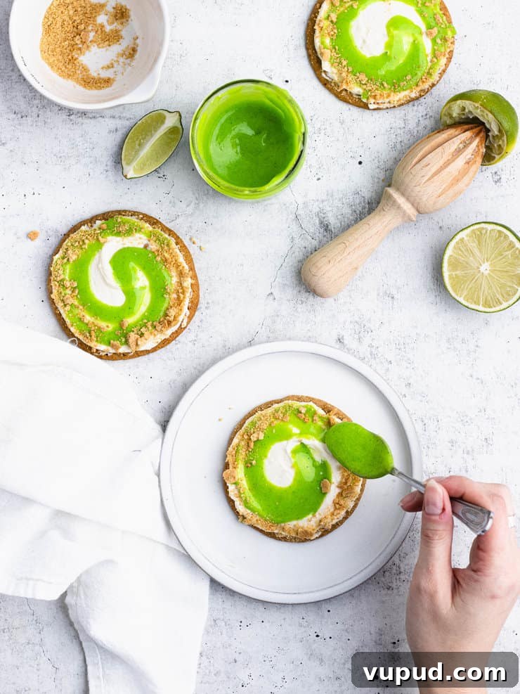 Zesty Key Lime Cookies Recipe: Tangy Citrus Cookie Delight 8 Overhead view of graham cracker cookies frosted with a white frosting with a smear of lime curd.