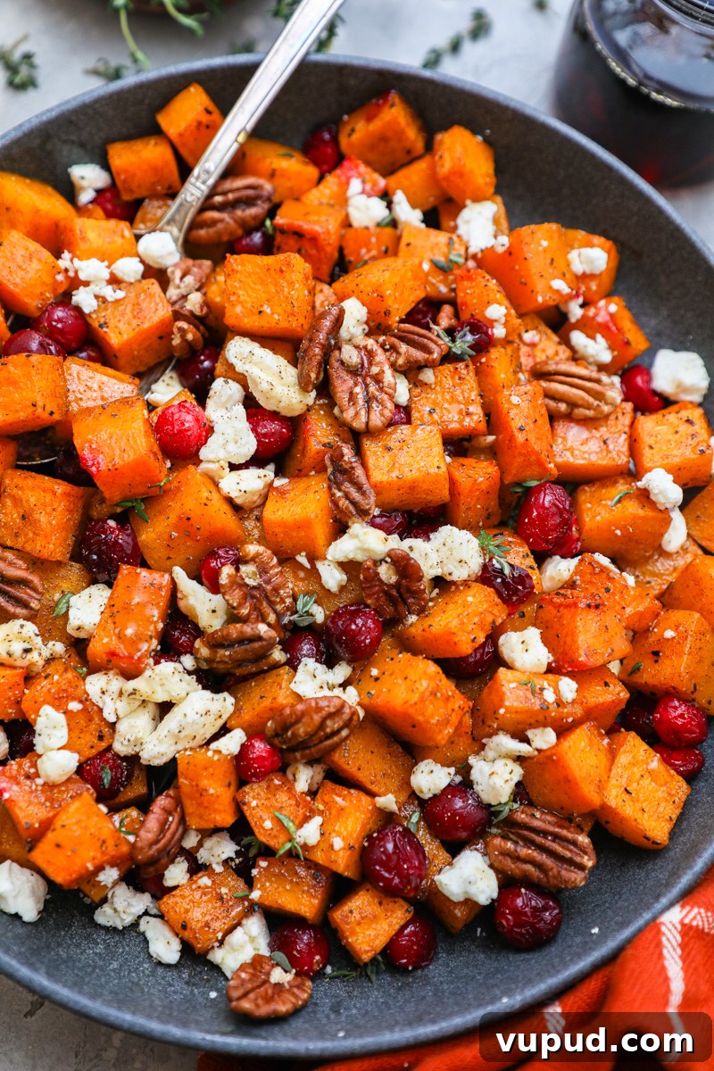 Maple-Roasted Butternut Squash with Cranberries and Feta 6 A serving bowl filled with maple roasted butternut squash with fresh cranberries and feta cheese