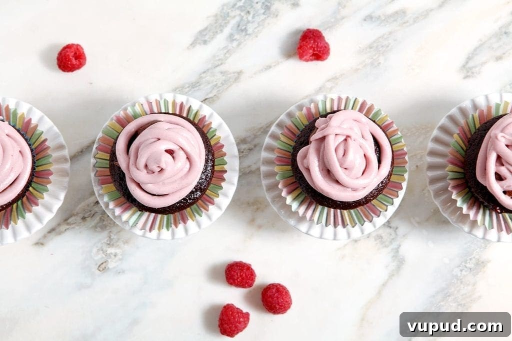 Chocolate Raspberry Cupcakes with Fresh Raspberry Buttercream 5 Overhead view of cupcakes with raspberries on table