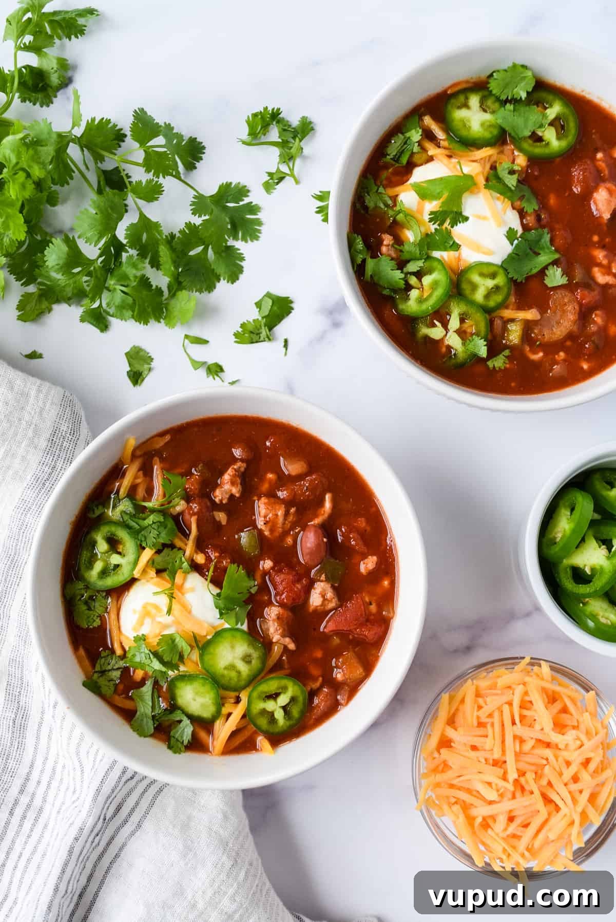 Slow Cooker Turkey and White Bean Chili Recipe 4 Slow Cooker Turkey and Bean Chili with cheddar cheese, cilantro, and jalapeños.