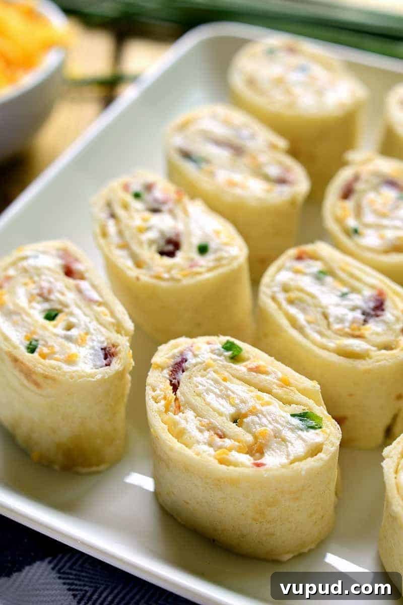 27+ Festive Christmas Finger Food Appetizers for Holiday Parties 11 Bacon cheddar pinwheels for the holidays