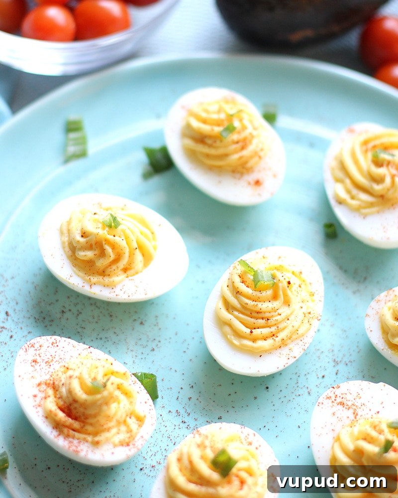 27+ Festive Christmas Finger Food Appetizers for Holiday Parties 6 Blue plate full of deviled eggs.
