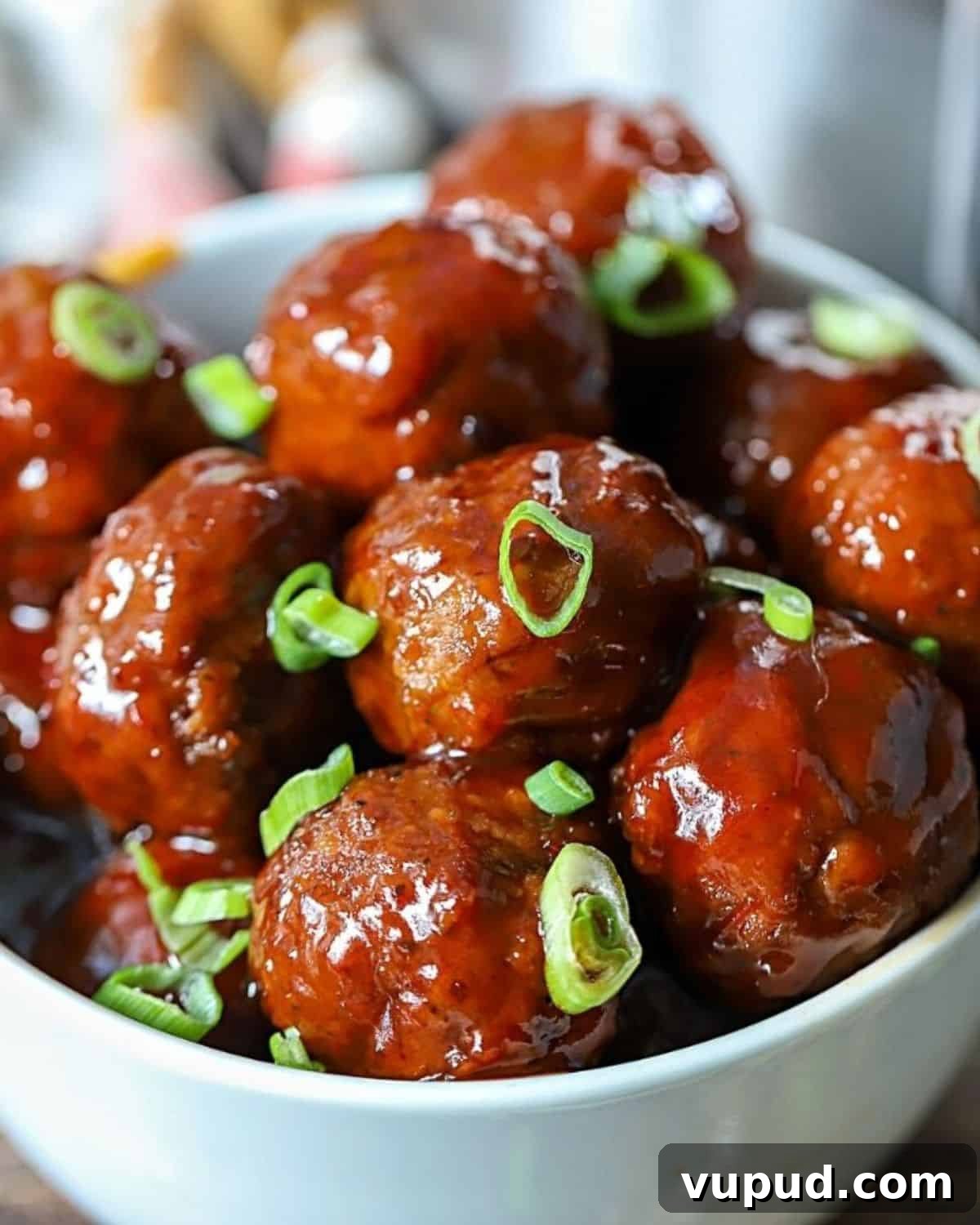 27+ Festive Christmas Finger Food Appetizers for Holiday Parties 7 Bowl full of grape jelly chili sauce meatballs.