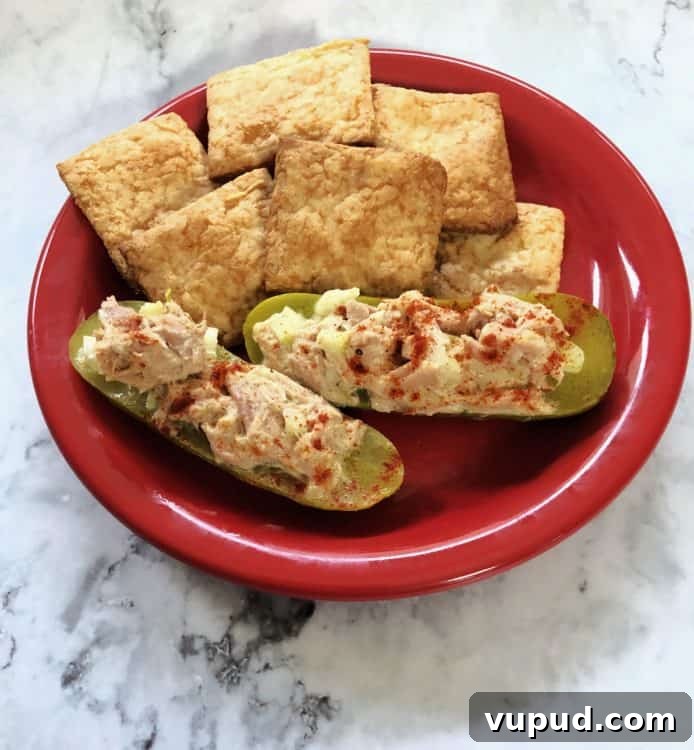 Tuna Salad Stuffed Avocado Boats for Quick Lunch 5 keto snack crackers with tuna boats on a small red plate