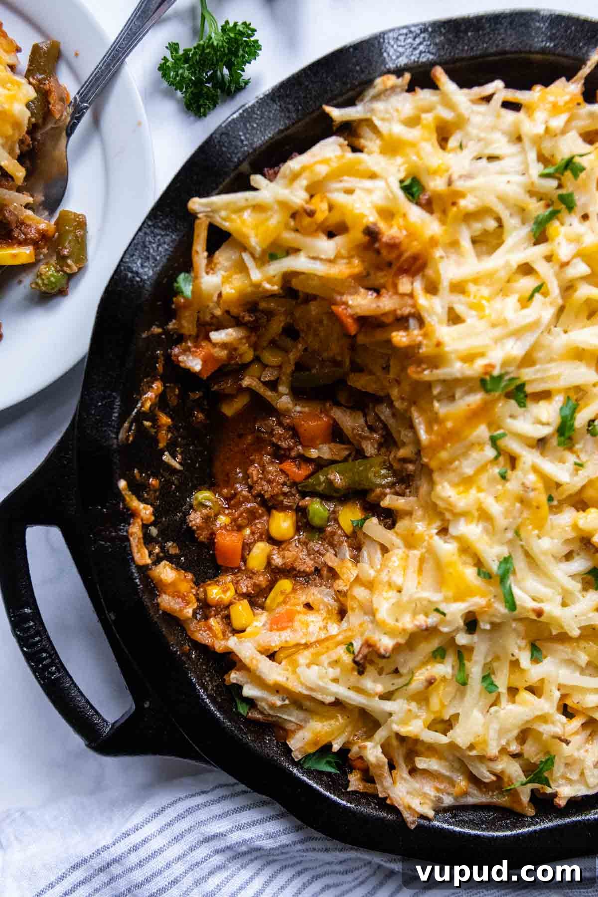 Quick Shepherd’s Pie Made with Crispy Hash Browns 2 overhead shot of shepherds pie with a scoop taken out.
