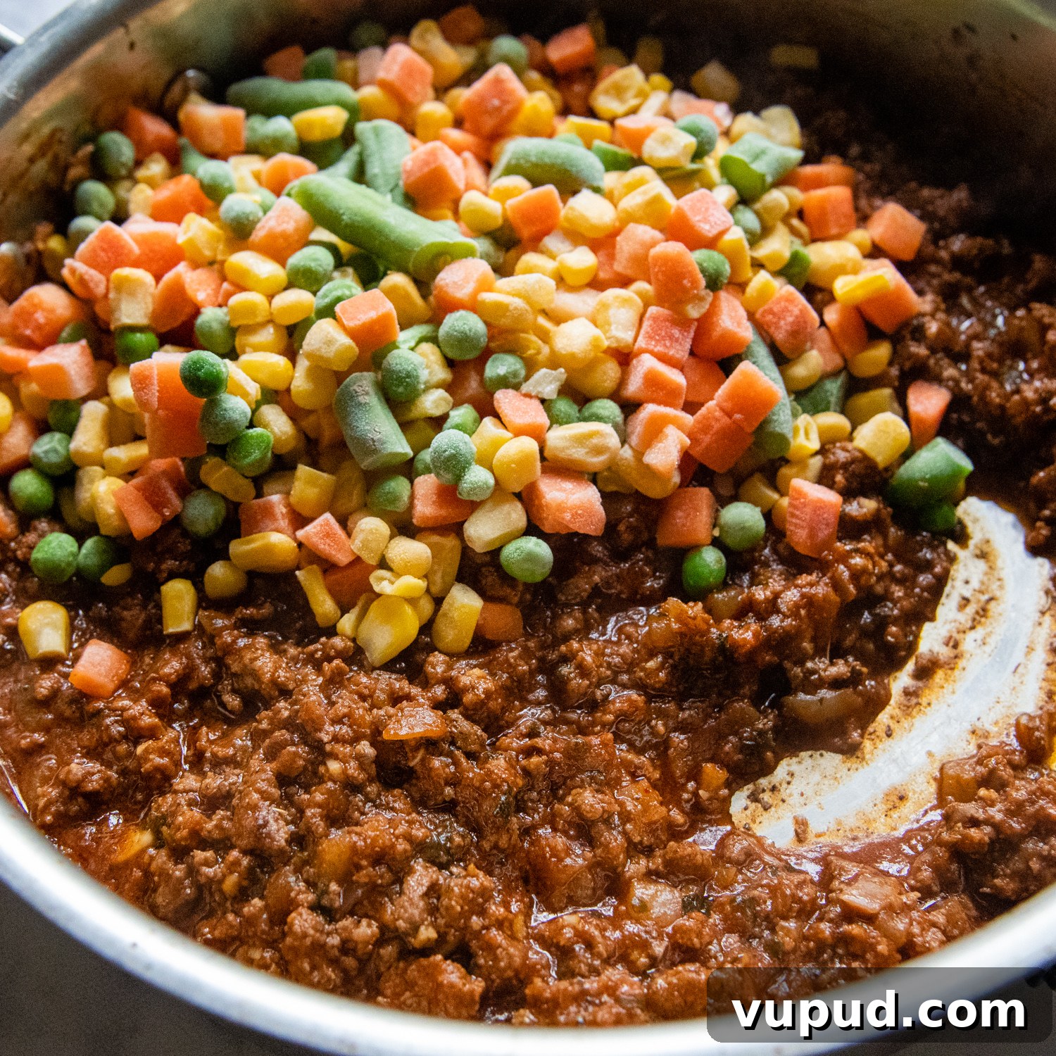 Quick Shepherd’s Pie Made with Crispy Hash Browns 5 frozen mixed veggies being added the beef.
