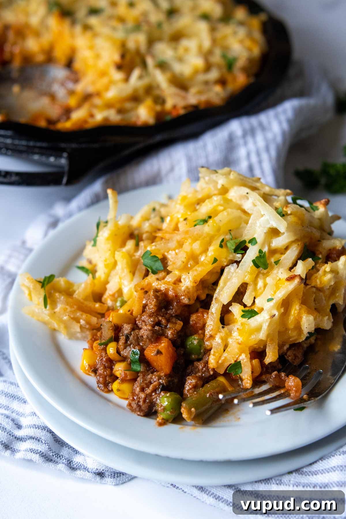 Quick Shepherd’s Pie Made with Crispy Hash Browns 7 a serving of cottage pie on a white plate.