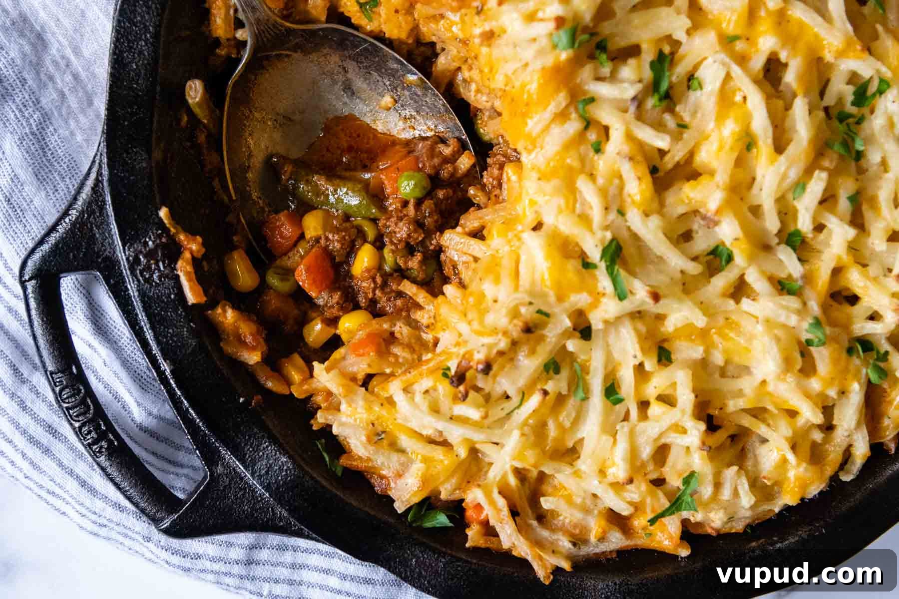Quick Shepherd’s Pie Made with Crispy Hash Browns 8 overhead of shepherds pie with a spoon going into dish.