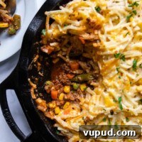 Quick Shepherd’s Pie Made with Crispy Hash Browns 9 overhead shot of shepherds pie with a scoop taken out.