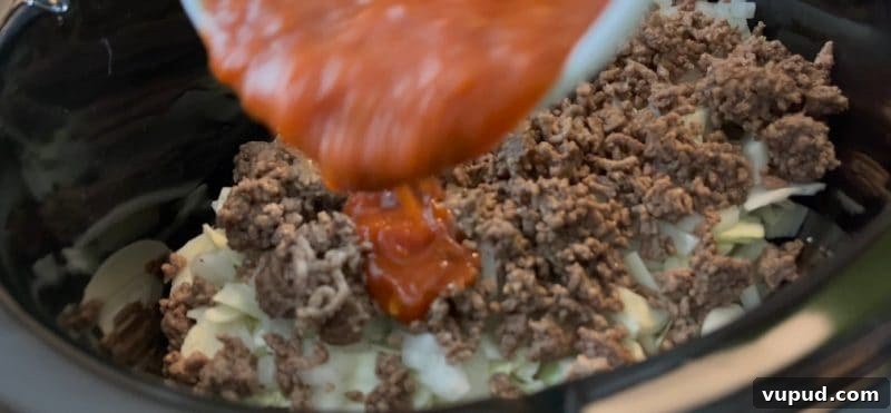 Slow Cooker Cabbage Casserole - Uses Spaghetti Sauce! pour in half a jar of spaghetti sauce on top