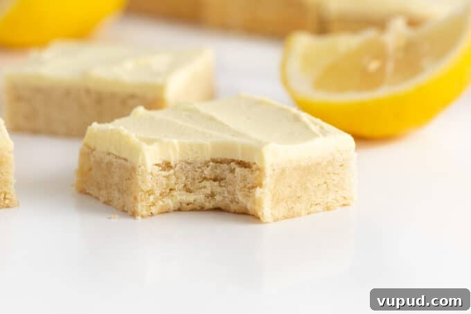 lemon sugar cookie bar with bite to show soft texture