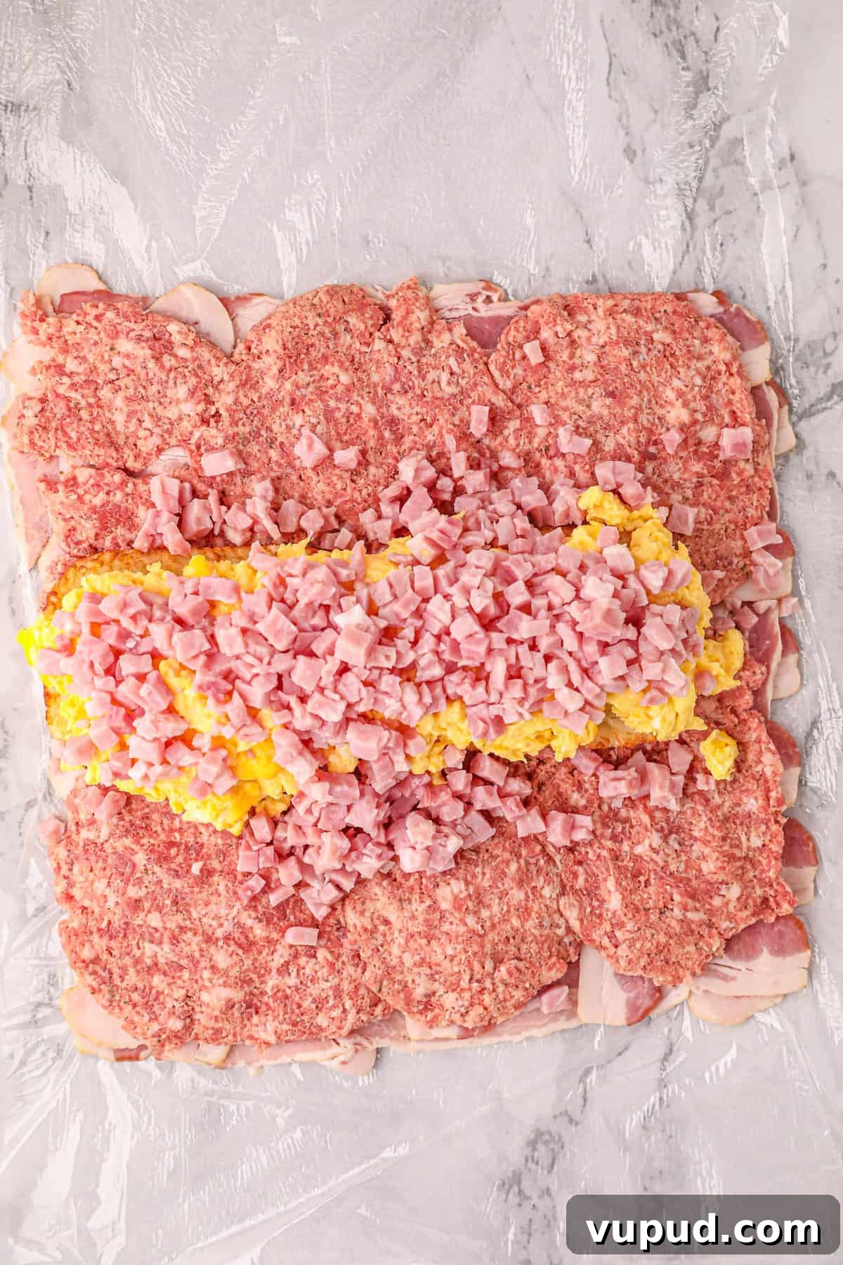 Smoked Breakfast Fatty: Savory Brisket-Wrapped Morning Roast 9 Sprinkling Cubed Ham Atop Scrambled Eggs for Smoked Breakfast Fatty Recipe