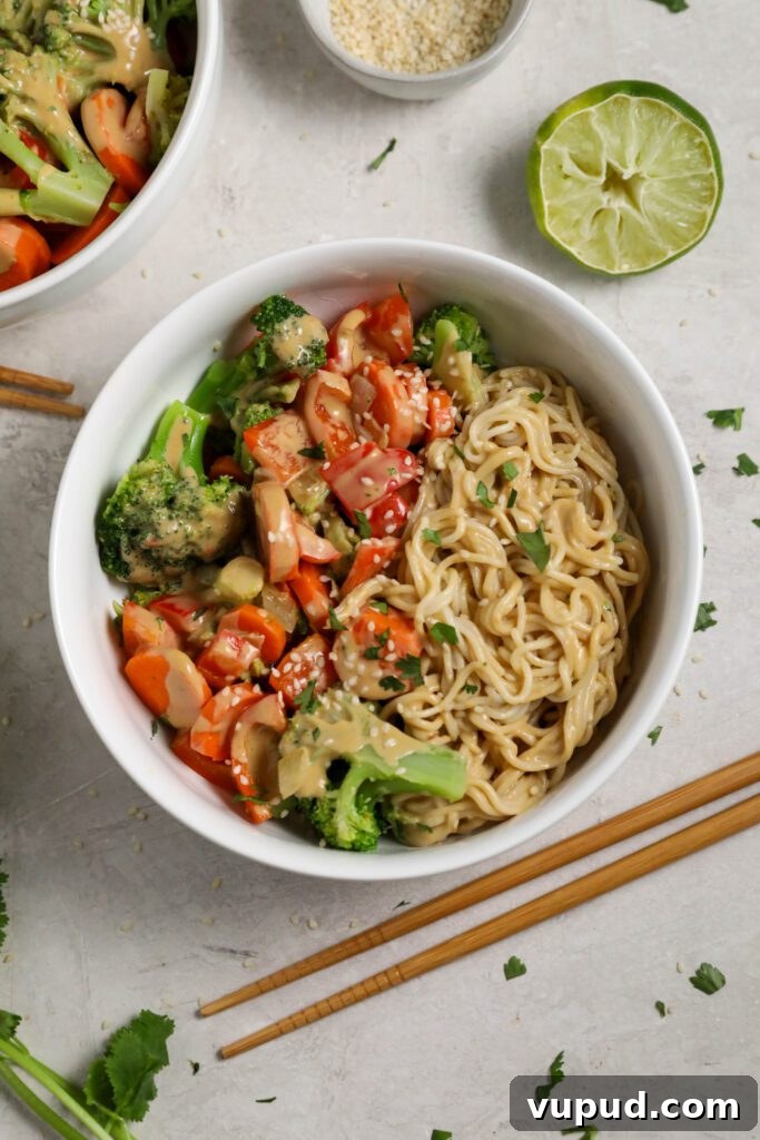 SunButter Peanut Butter Ramen Bowls: Creamy Savory Noodle Recipe 2 SunButter Ramen Noodle Bowls served in a bowl with cilantro and sesame seeds and chopsticks by Flora & Vino