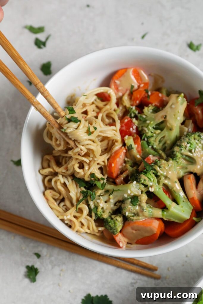SunButter Peanut Butter Ramen Bowls: Creamy Savory Noodle Recipe 9 chopsticks picking up SunButter Ramen Noodle Bowls by Flora & Vino