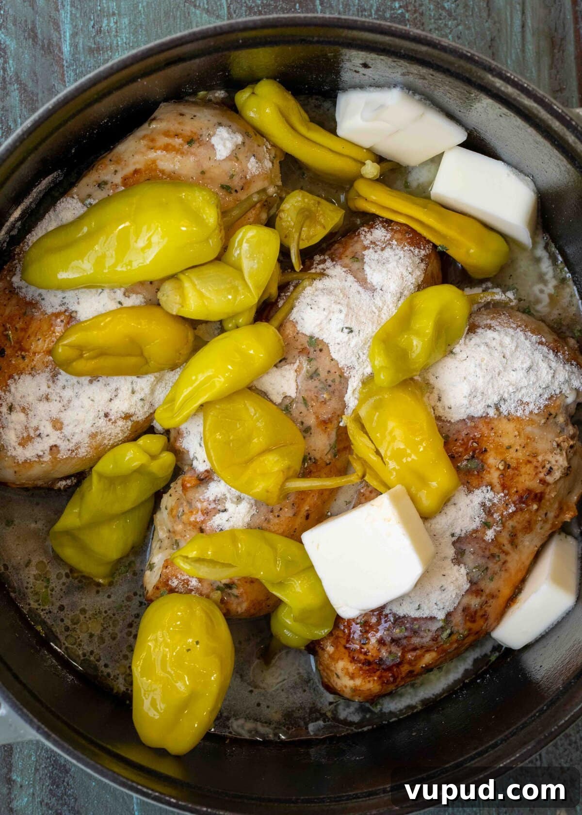 Crockpot Mississippi Chicken: Slow Cooker Recipe for Tender Flavor 6 pepperoncini, brine, butter, and ranch seasoning over seared chicken breasts in a dutch oven