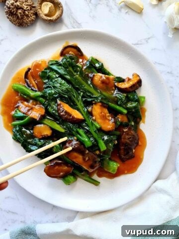 Plate of Chinese broccoli with mushrooms and sauce
