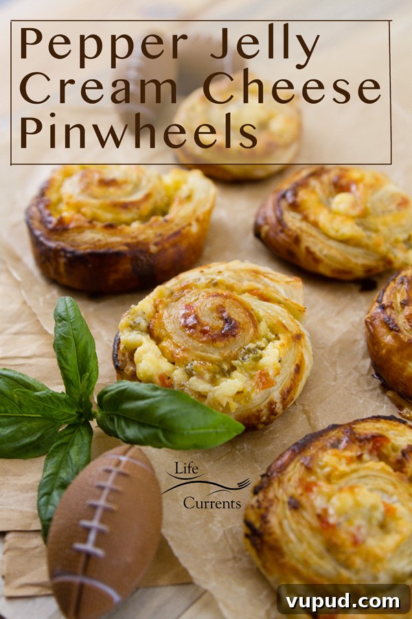 Pepper Jelly Cream Cheese Pinwheels on parchment paper with a small football and basil