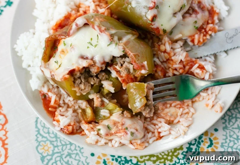 Slow-Cooker Stuffed Bell Peppers for Weeknight Dinner 3 Crock Pot Stuffed Sweet Bell Peppers served over a bed of white rice