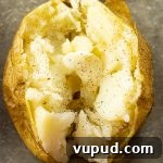 Crispy Oven-Roasted Potatoes with Garlic and Herbs 7 baked potato split in half with melting butter