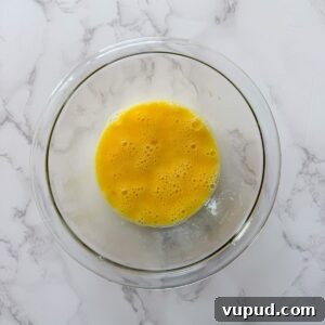 Crispy Homemade Mozzarella Sticks with Marinara Dipping Sauce 6 Eggs whisked in a bowl.