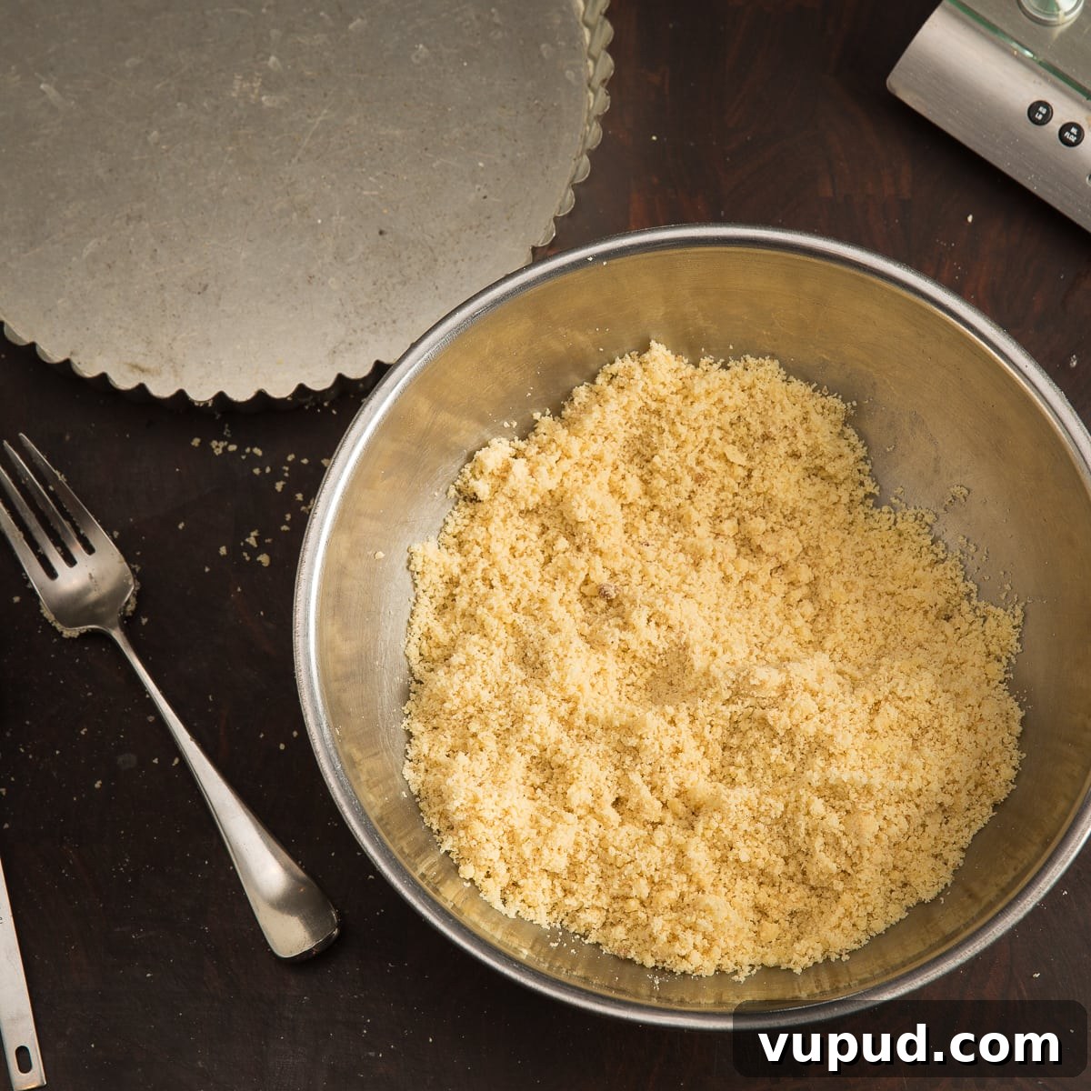 Grain-Free, Gluten-Free Tart Crust Recipe for Flaky Pastry 4 Almond flour and coconut flour in a bowl with a fork for mixing.