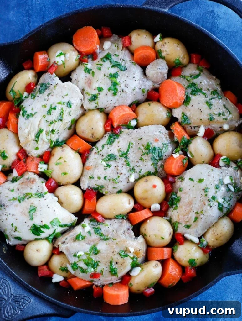 oven baked chicken and potatoes top down shot of Chicken and potatoes in a skillet