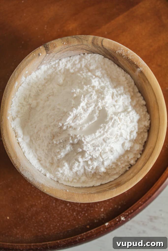 Soft & Fluffy Gluten-Free Hot Cross Buns: Simple Recipe for Spring 13 overhead shot of a wooden bowl of tapioca starch.