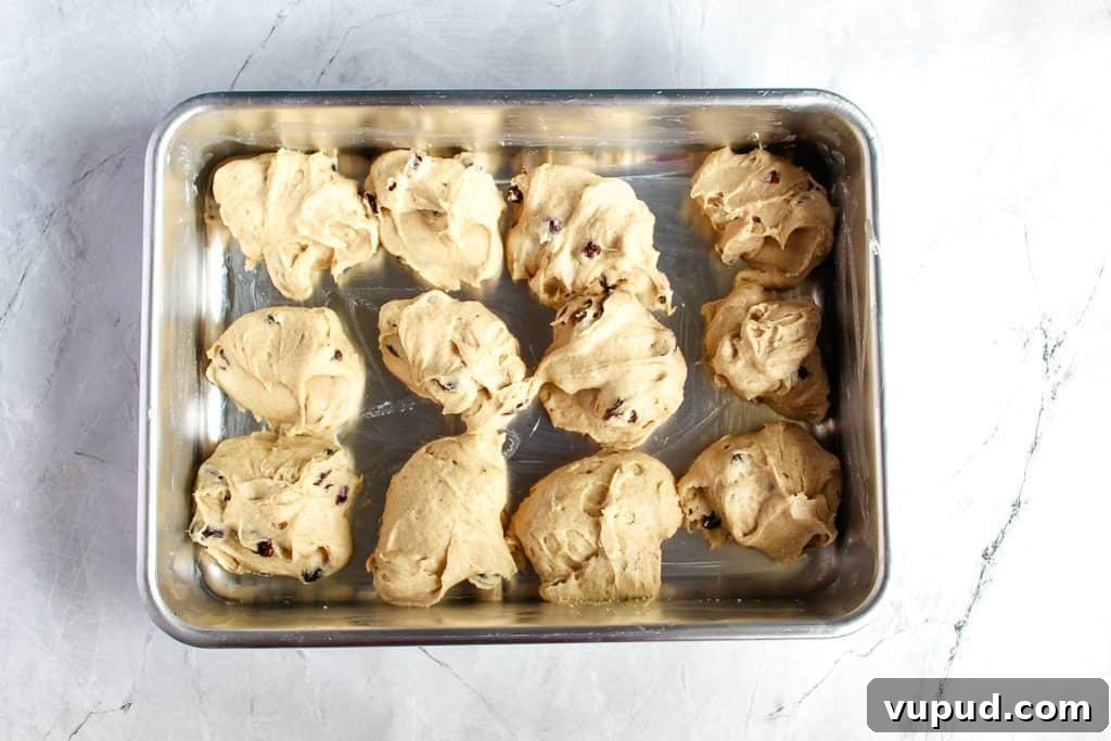 Soft & Fluffy Gluten-Free Hot Cross Buns: Simple Recipe for Spring 10 gluten-free hot cross buns portioned out in a baking pan