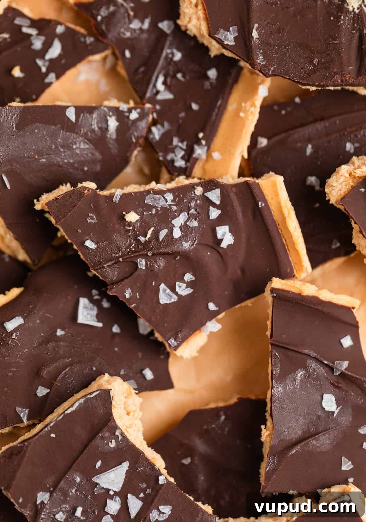 How to Make Creamy Greek Yogurt Bark with Fruit & Nuts 2 Frozen peanut butter Greek yogurt bark covered in chocolate with sea salt flakes on top.
