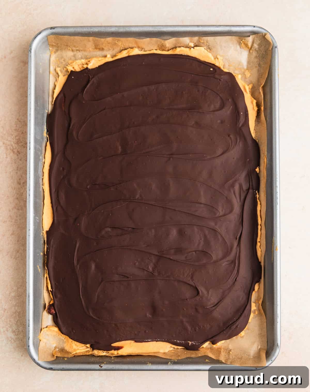 How to Make Creamy Greek Yogurt Bark with Fruit & Nuts 4 Peanut butter and dark chocolate frozen Greek yogurt bark on sheet pan.