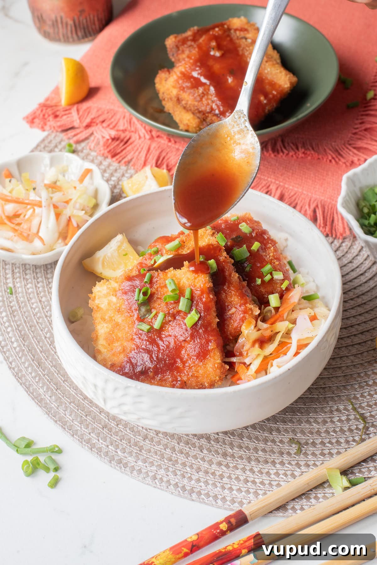 Crispy Tofu Katsu Recipe: Crunchy Plant-Based Cutlets 2 An image of drizzle sauce onto the tofu katsu.