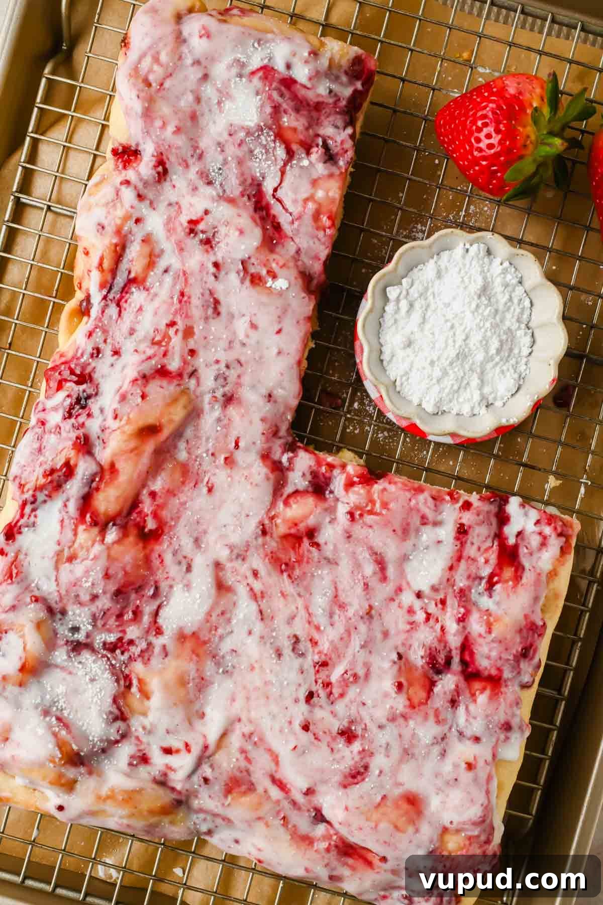 Raspberry Jam Sweet Focaccia Recipe for Soft, Fruity Bread 8 sweet focaccia spread with raspberry jam and powdered sugar glaze on wire rack.