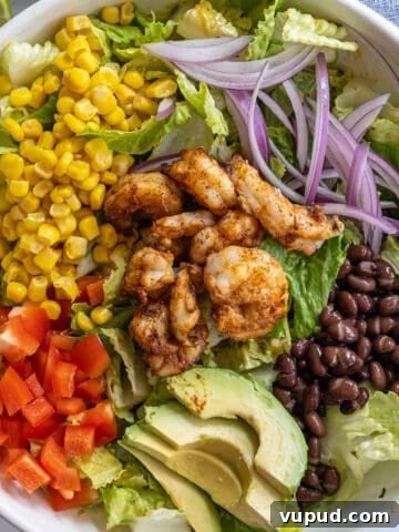 grilled shrimp salad with beans, red pepper, corn, red onion, beans, and avocado