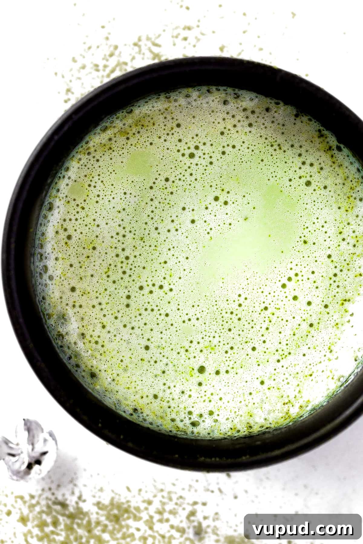 Creamy Oat Milk Matcha Latte Recipe for Perfectly Frothy Mornings 2 Overhead view of a frothy oat milk matcha latte in a black mug.