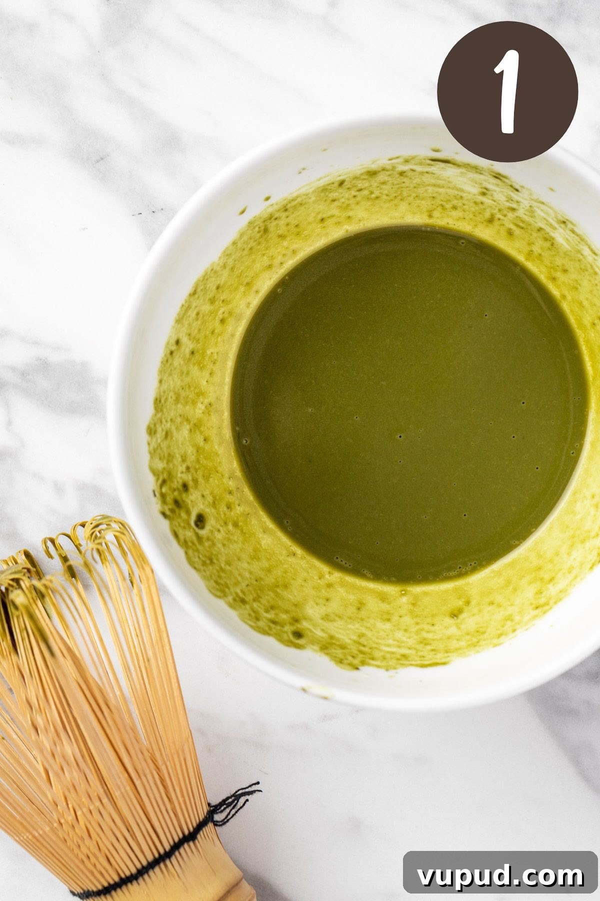 Creamy Oat Milk Matcha Latte Recipe for Perfectly Frothy Mornings 4 A process photo illustrating step 1: whisking the matcha powder and water together.