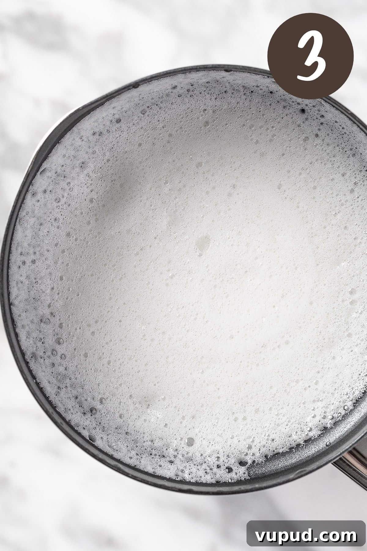 Creamy Oat Milk Matcha Latte Recipe for Perfectly Frothy Mornings 6 A process photo illustrating step 3: froth the oat milk.