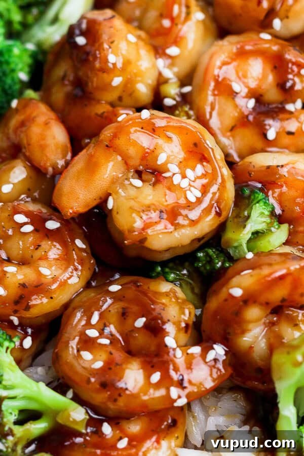Sticky Grilled Teriyaki Chicken Recipe with Charred Scallions 9 A plate of rice covered with teriyaki shrimp and broccoli.
