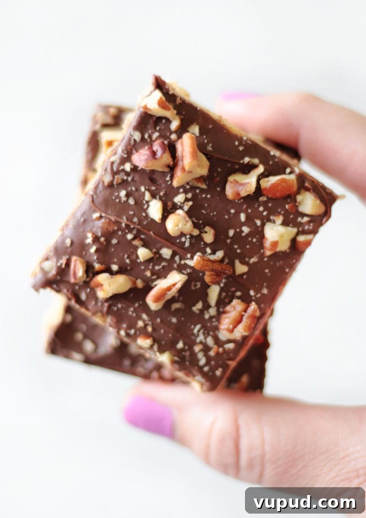 Classic Chewy Toffee Bars Recipe with Buttery Shortbread 3 hand holding two classic toffee bars