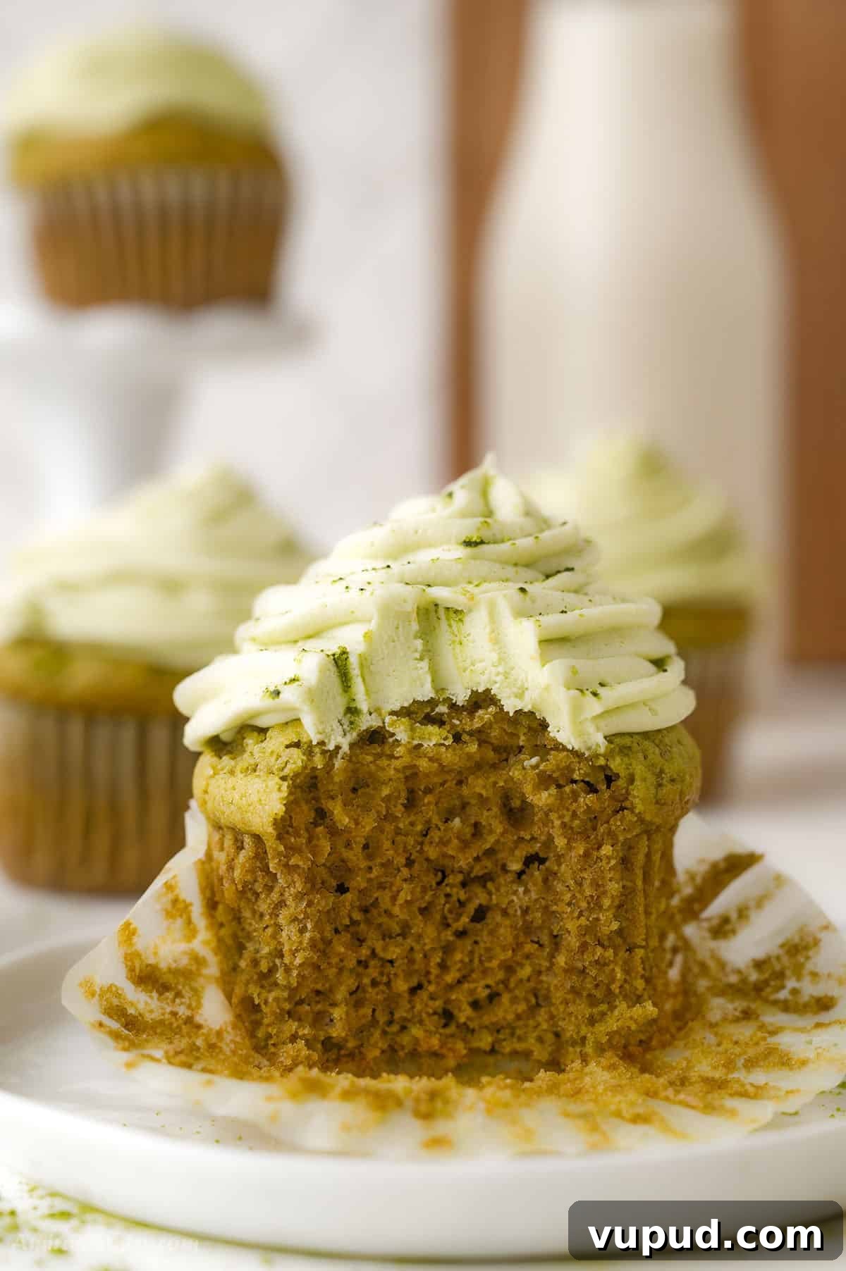 Matcha Cupcakes Recipe: Moist Green Tea Cupcakes with Frosting 5 A bite taken from one cupcake to show texture.