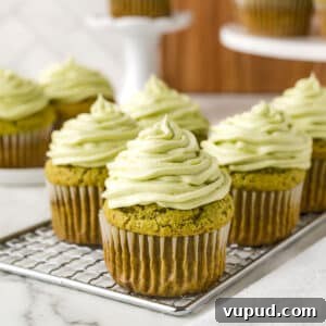 Matcha cupcakes on a cooling rack.