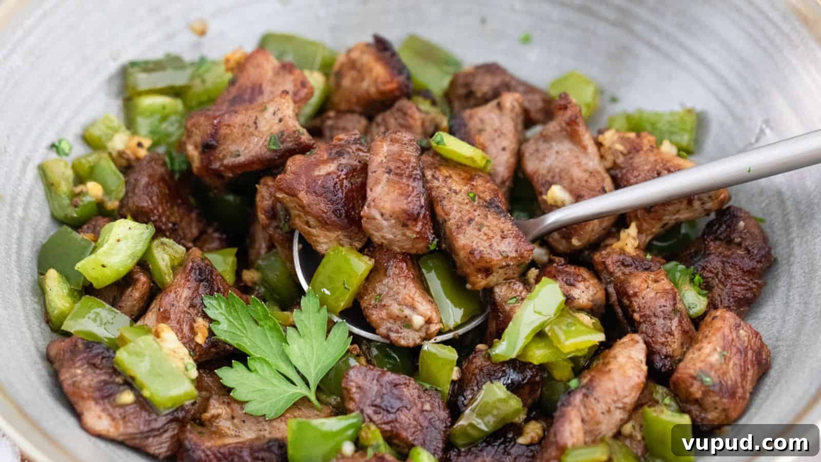 30 Flavorful Low-Carb Main Dishes That Feel Like Real Meals 16 A bowl of meat and green peppers with a spoon.