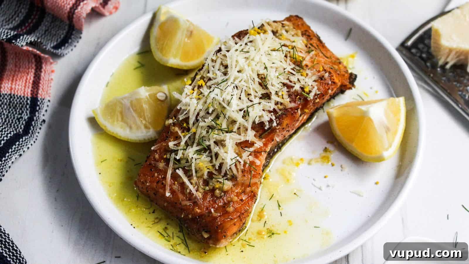 30 Flavorful Low-Carb Main Dishes That Feel Like Real Meals 19 A plate of salmon on a white plate with lemon slices on it.